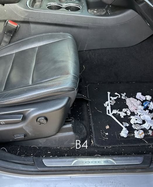 Front seat and floor covered in crumbs and debris before detailing