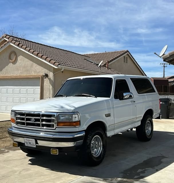 Classic white Ford Bronco detailed in a driveway