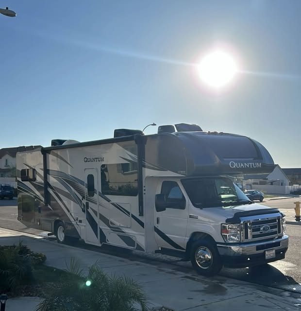 Class C motorhome washed and detailed under a bright sky