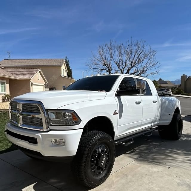 White Ram 3500 dually lifted on black wheels after a detail
