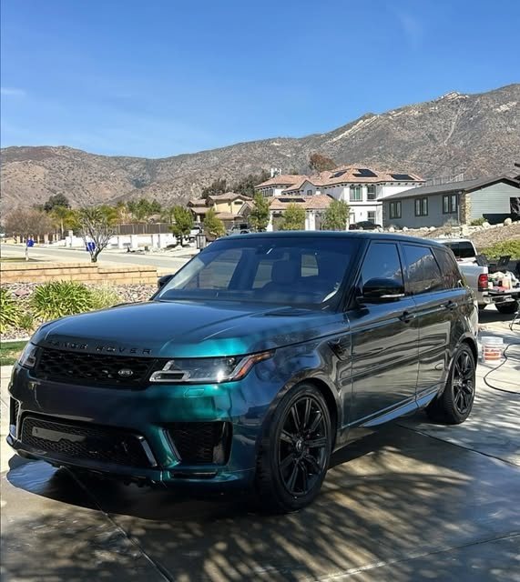 Deep green Range Rover Sport freshly detailed in a Yucaipa driveway