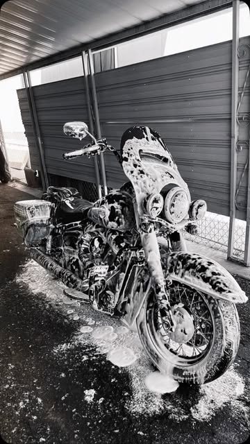 Motorcycle in thick foam before a rinse